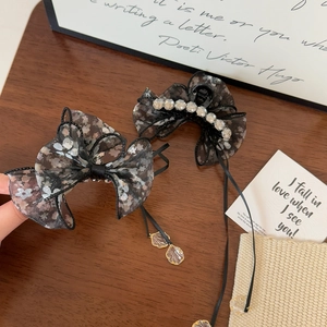 Floral organza bow hair clip set with rhinestones and ribbon tassels on wood background