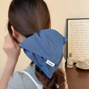 Navy blue denim bow scrunchie with handmade tag on a model for a vintage hairstyle