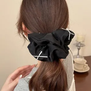 Black fluffy oversized scrunchie with tiny white ribbons for a sweet ballet style