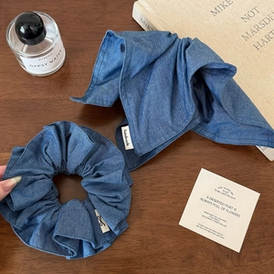 Deep blue denim scrunchie and hair ribbon set with handmade label on wooden background
