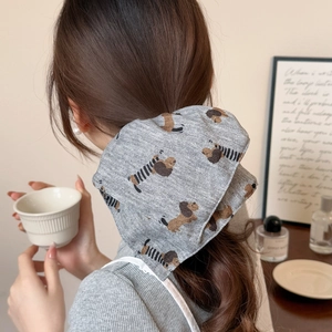 Korean style grey ruffled scrunchie with cute dog prints worn on a messy bun hairstyle