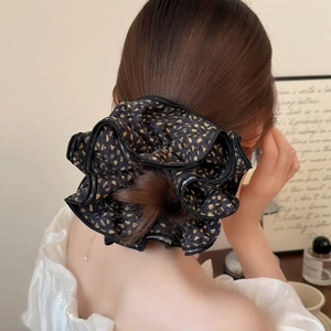 Elegant black and gold leopard print scrunchie for women's hairstyle fashion