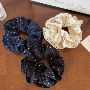 Three-pack of French-style polka dot hair scrunchies in navy, black, and cream white