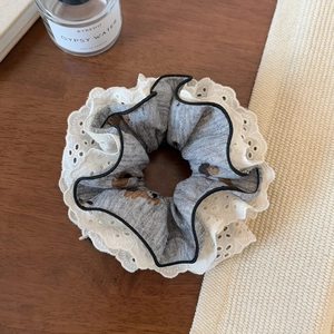 Detail of grey hair scrunchie with cute bear print and white eyelet lace trim