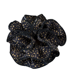 Elegant black scrunchie with gold foil floral pattern and ruffled edge fabric design