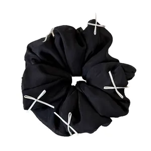 Sweet fluffy black chiffon scrunchie with white ribbon bows in elegant ballet style