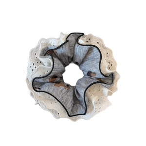 Chic dog print scrunchie featuring grey patterned fabric and delicate white lace trim