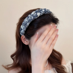 Braided ink print wide headband with twisted design for a high skull top hairstyle look