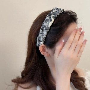 Elegant wide ink-print braided headband with a black and white vintage twist design