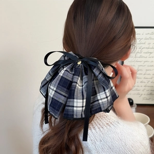 Blue plaid bow scrunchie with black ribbons and gold heart charm on ponytail