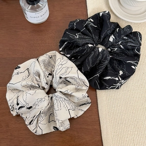 Set of two large scrunchies with elegant line patterns in cream white and black fabric