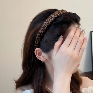 Classic leopard print velvet sponge headband worn by a woman for stylish daily hair styling