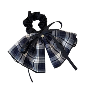 Plaid pattern bow scrunchie with a gold heart pendant and elegant black ribbons