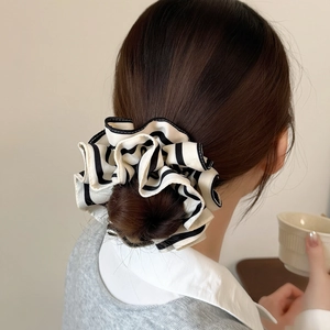 Retro black and white striped oversized scrunchie on a ponytail for women hair styling