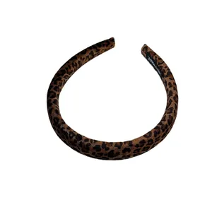 Chic leopard print velvet padded headband with handmade label on white background