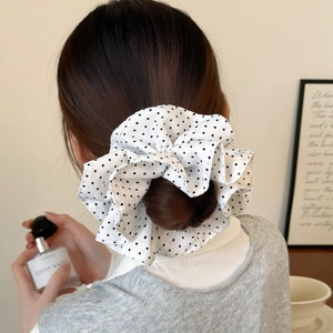 French style white chiffon scrunchie with black polka dots shown on a model's hair