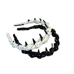 Gothic style polka dot headbands in black and cream featuring twisted satin fabric design