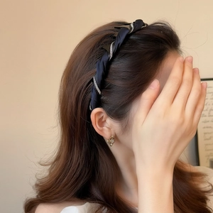 Detail of luxury black silk headband with crystal chains shown on model side profile