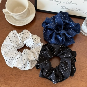 Three-piece set of French polka dot scrunchies in white, navy, and black fabric