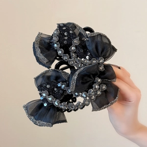 Pince à cheveux élégante en nœud noir ornée de strass brillants pour chignon chic