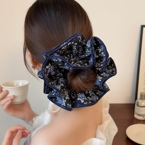 Floral navy blue oversized hair scrunchie shown from a stylish side-back view