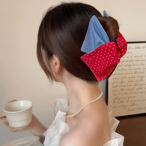 Sweet red polka dot and blue denim bow hair claw clip for a French half-up hairstyle