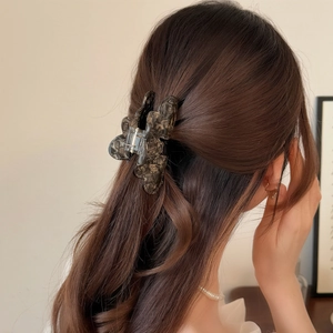 Elegant tortoiseshell acetate hair claw clip for a stylish half-up hairstyle