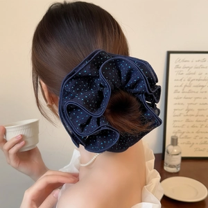 Navy blue oversized polka dot scrunchie made of textured fabric for ponytail styling