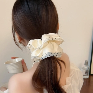 Elegant cream satin scrunchie with black polka dot mesh trim for ponytail styling