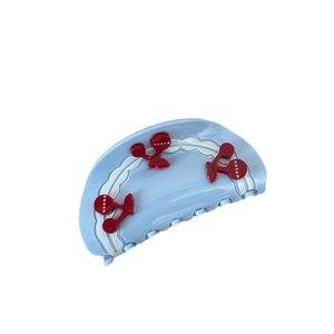 Blue acetate hair claw clip with red cherry 3D designs and sparkling rhinestones
