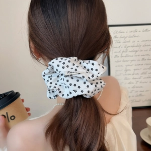 Floral fabric scrunchie with black print on white for elegant ponytail hairstyles