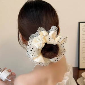 Polka dot mesh hair scrunchie shown on a ponytail with double-layered satin fabric