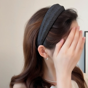 Padded shimmering black wide headband for women showing high-volume hair styling effect