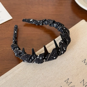 Detail of black polka dot fabric headband featuring double-row rhinestone chains and non-slip teeth