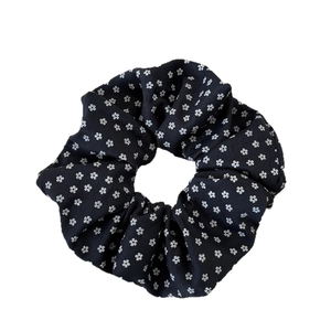 Navy blue floral scrunchie with delicate white flower pattern for hair styling