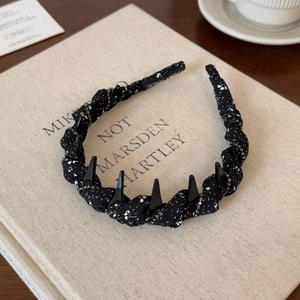 Polka dot fabric headband with spiked rivets and rhinestones shown in a lifestyle setting