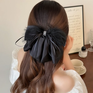 Elegant black satin bow hair claw with feather trim and diamonds for women