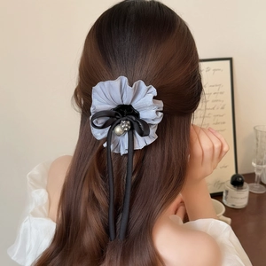 Elegant mauve ruffled flower hair claw with black ribbon bow and pearl details