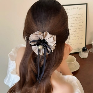 Elegant champagne pleated chiffon hair claw clip with black ribbon bow and pearl bead