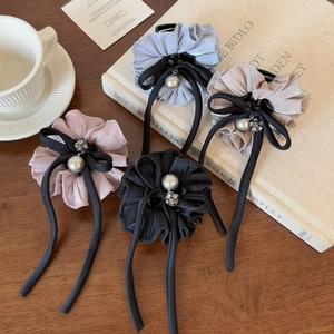 Elegant bow hair clips with pearls and ruffled fabric in blue, gold, pink, and black colors