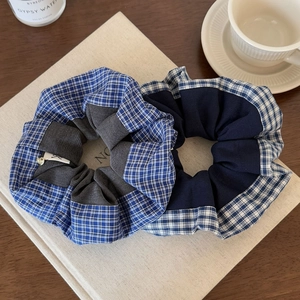 Vintage blue checkered scrunchies set on aesthetic books with a coffee cup background