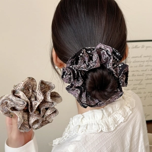 Elegant French floral chiffon hair scrunchies displayed in a stylish bun hairstyle