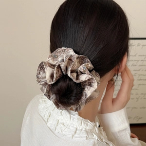 Elegant vintage floral large fabric scrunchie with silk luster on a soft low bun