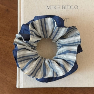 Blue and white striped scrunchie on vintage book with double-layered fabric design