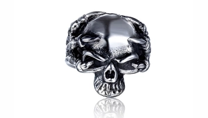 Macro shot of punk black skull ring with oxidized silver finish and bone claw design