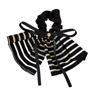 French style striped bow scrunchie with long ribbons and a small gold charm pendant