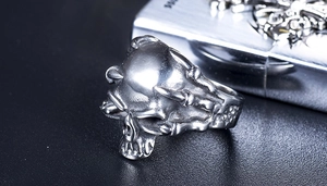 Macro shot of gothic black skull ring with skeletal bone claws in silver stainless steel