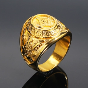 Macro shot of gold stainless steel Freemason ring with engraved G symbol and ornate carvings