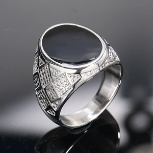 Classic men's stainless steel signet ring with oval black stone and geometric carving