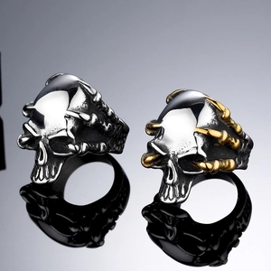 Punk style stainless steel skull rings featuring giant claws on a black reflective surface
